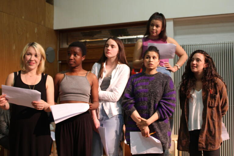young performers holding scrips during a rehearsal
