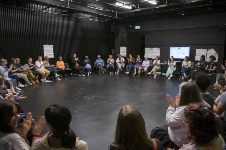 Attendees sitting in a circle seating at the "Five Years On from #MeToo: What Next for Drama Schools at LAMDA" in June 2022